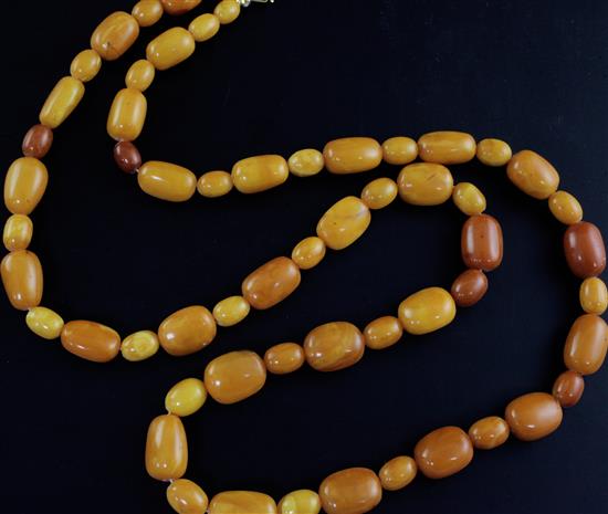 A single strand oval amber bead necklace, 104cm.